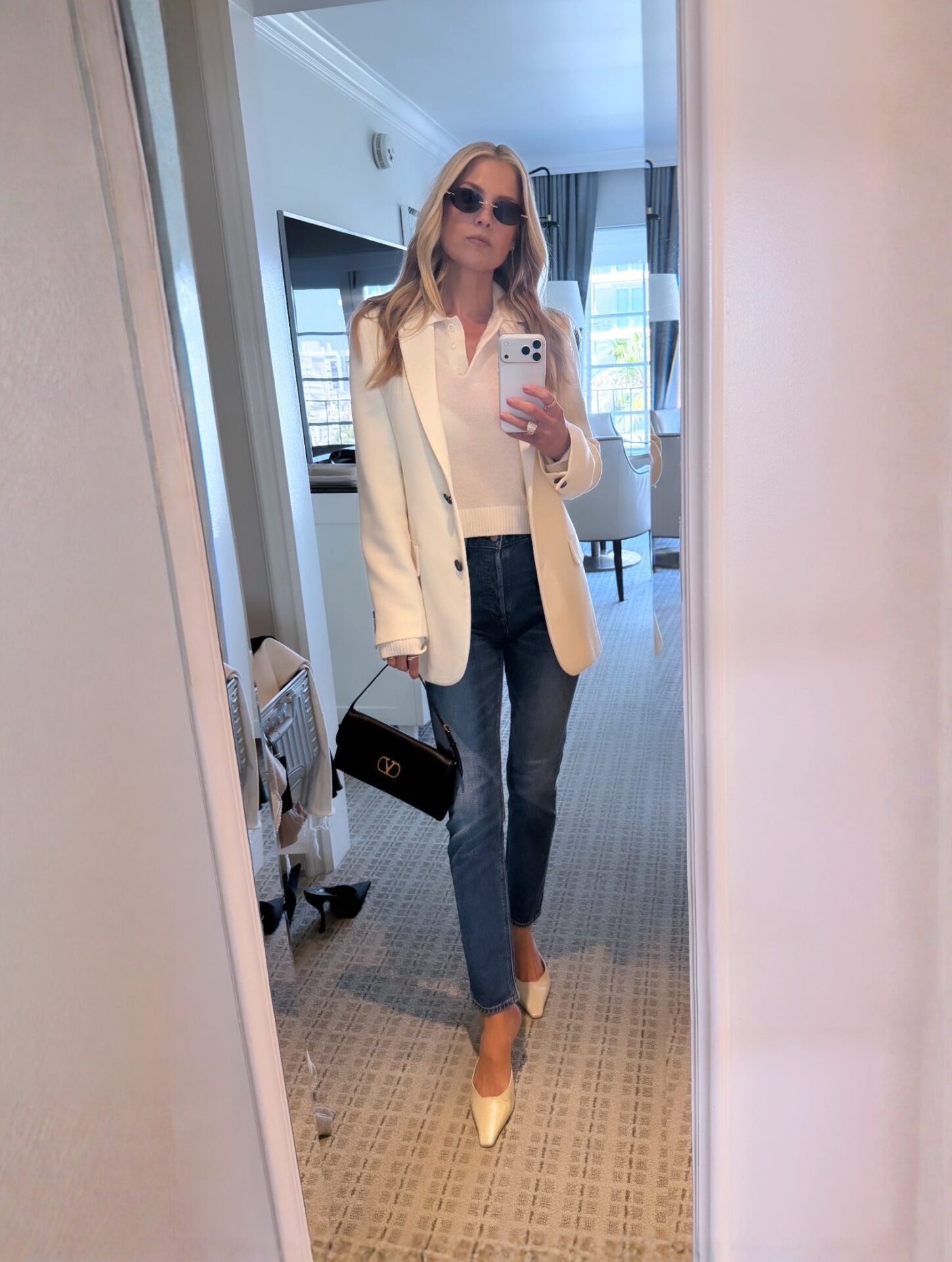 Ali Larter Cream Sweater + Black Valentino Garavani Bag